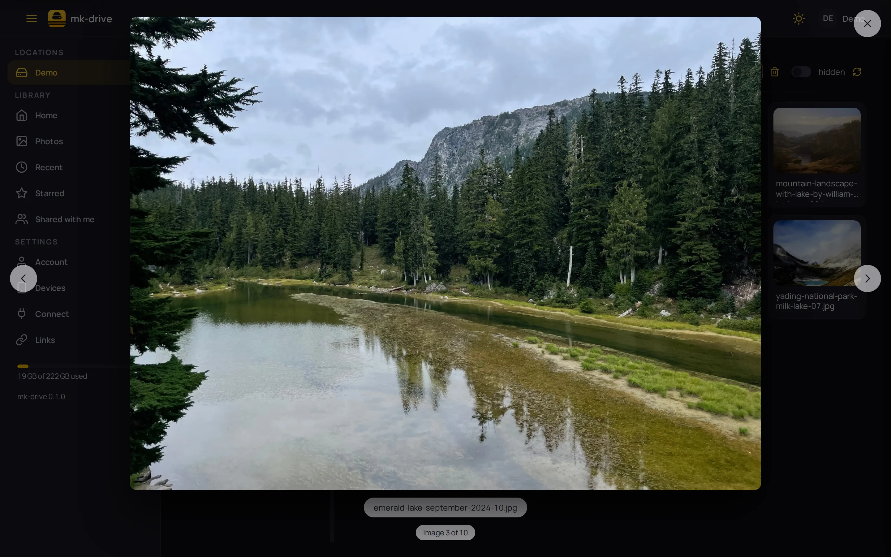A photo of a forest lake open in the lightbox, with arrows to the previous and next photo and "Image 3 of 10" below